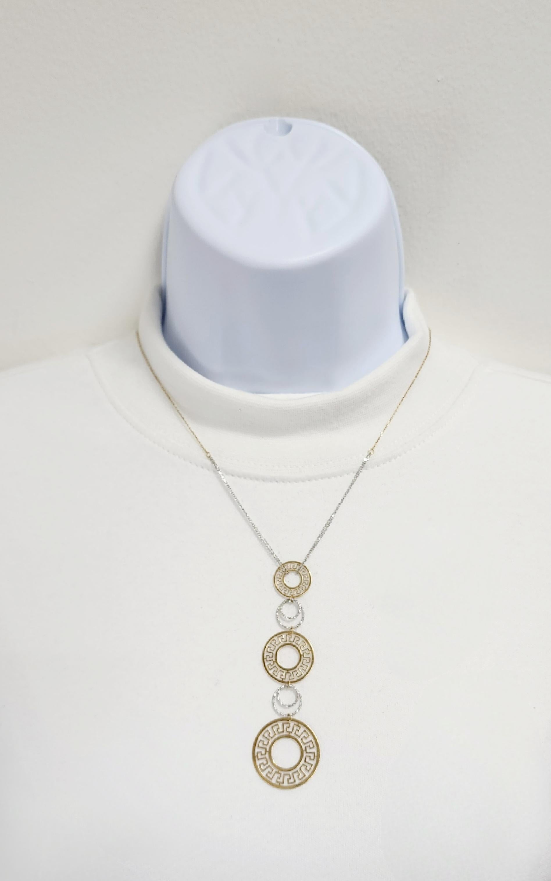 Beautiful circular cut out design pendant necklace handmade in 18k white and yellow gold.  Length of chain is 18