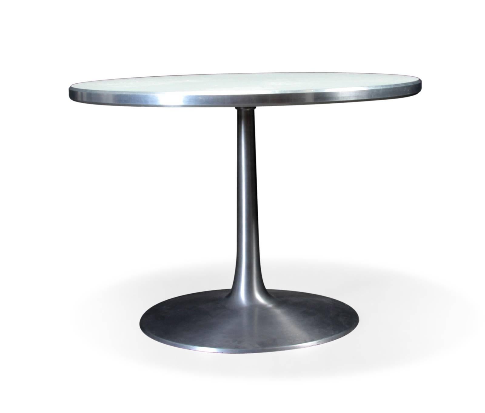 Poul Cadovius. Circular dining table, model 631. Trumpet base in brushed aluminum die-cast. Table top in white laminate with aluminum edge. Made for France og Søn. Measure: H 71, approximate 100 cm. Signs of wear, scratches on the foot.