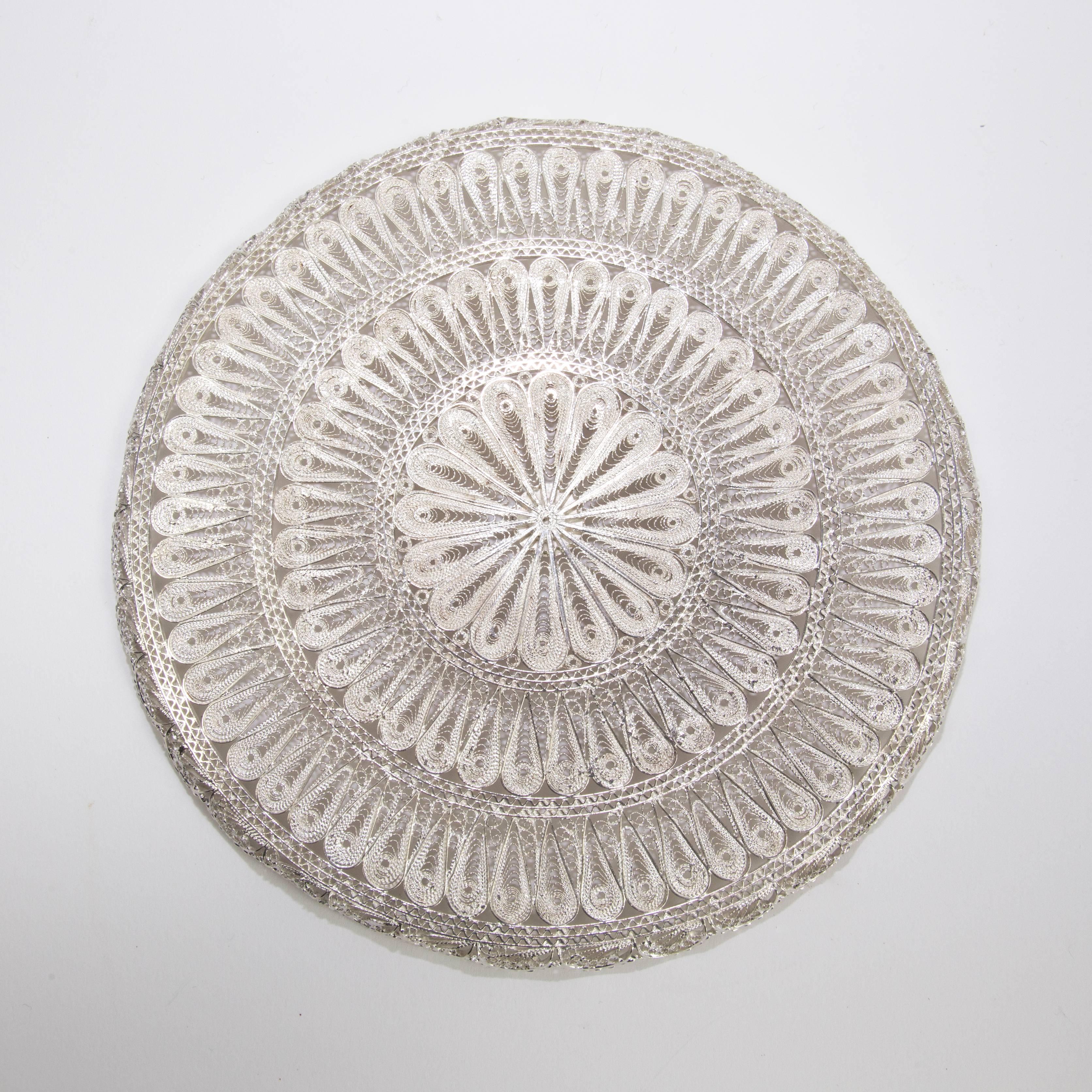 Solid Silver handcrafted circular tray with raised scalloped edge; measuring approximate 7 inches in diameter; weighing approximate 210.16 gm/6.76oz. Tested to a high grade silver.