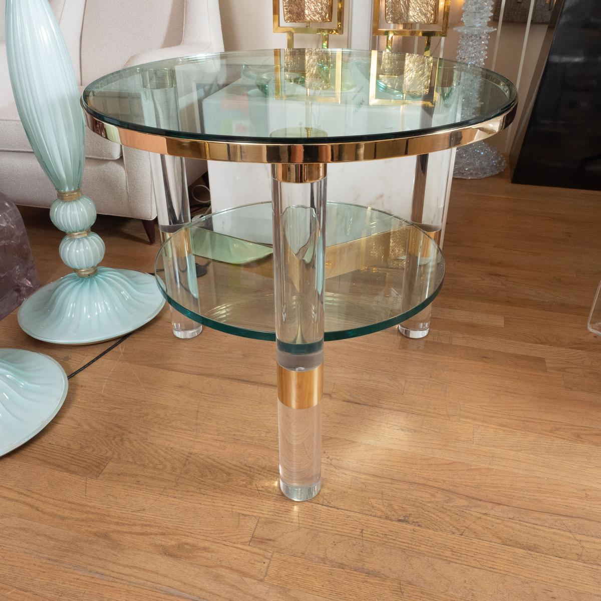 Circular glass and Lucite two tier side table with brass details attributed to Karl Springer.