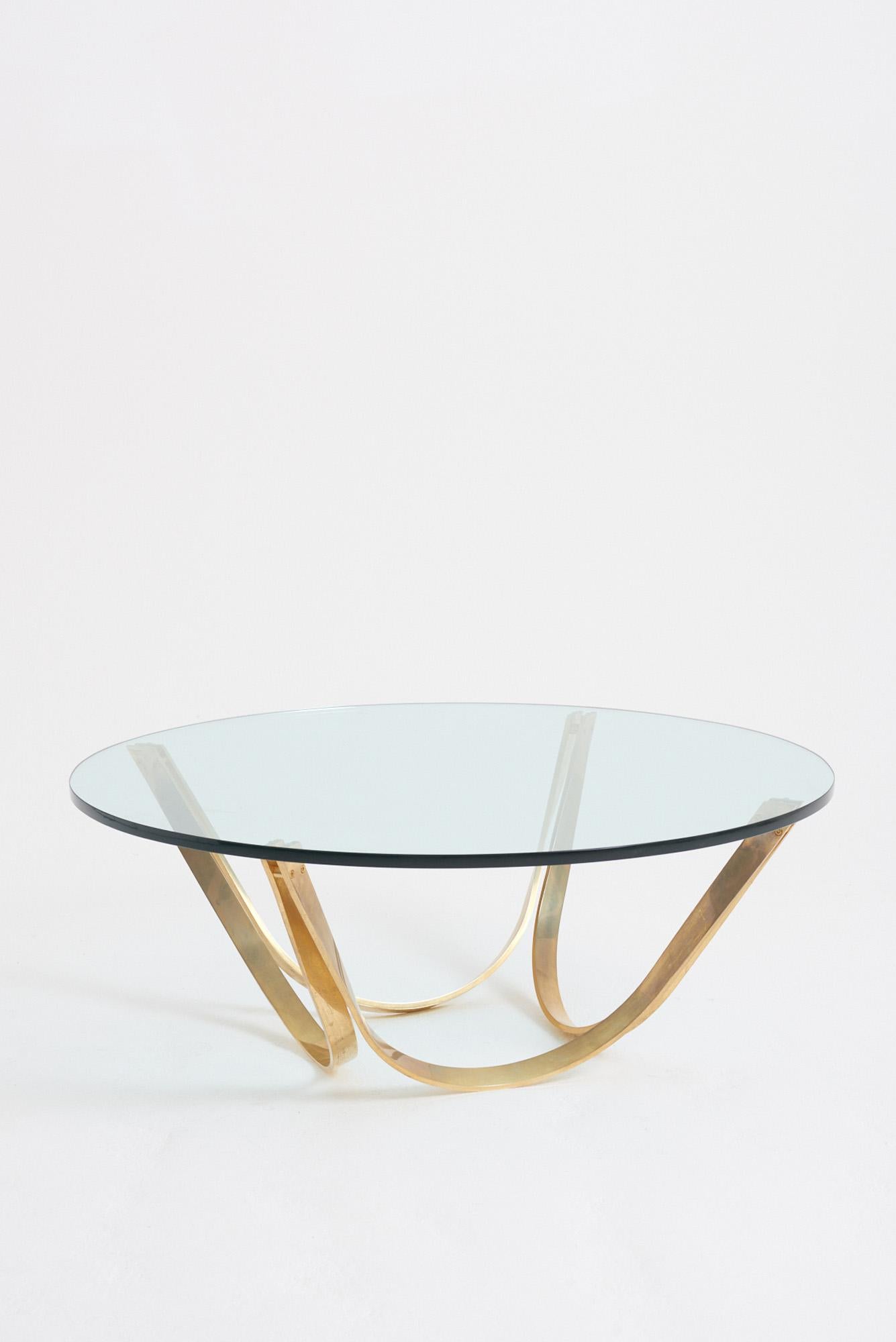 A gilt lacquered steel and glass top circular coffee table.
Sweden, 1970s