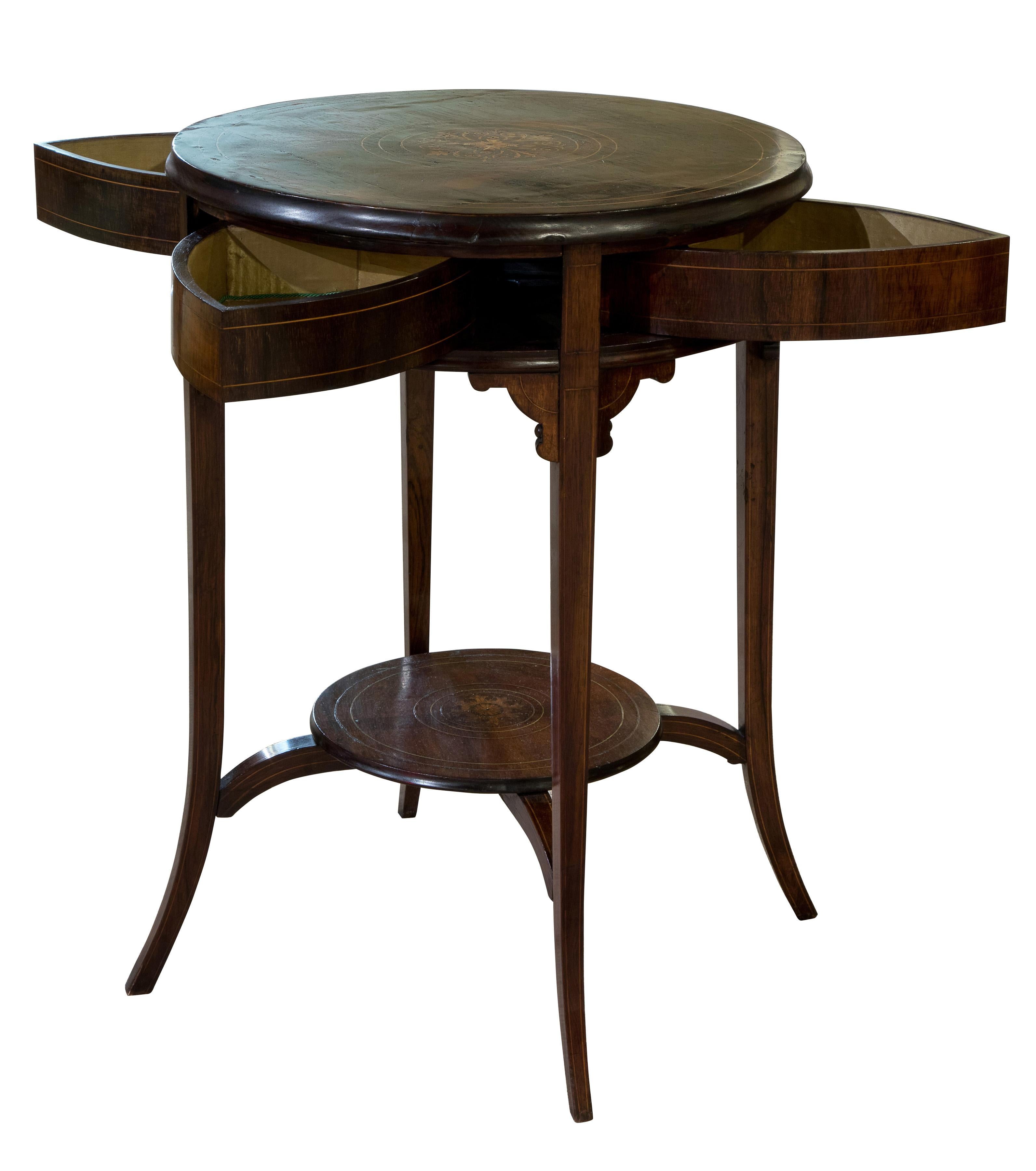 Circular inlaid drum table with rotating top to reveal four drawers.

Highly unusual Victorian piece.