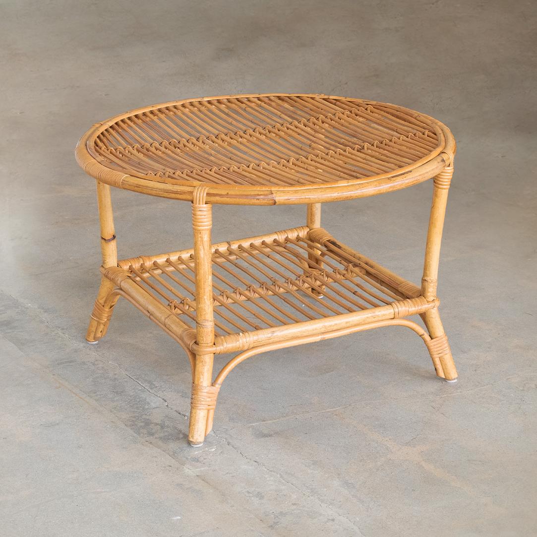 Great two-tier rattan circular table from Italy, 1960's. Original rattan slatted top and lower shelf. Great wrapped rattan detailing on legs.