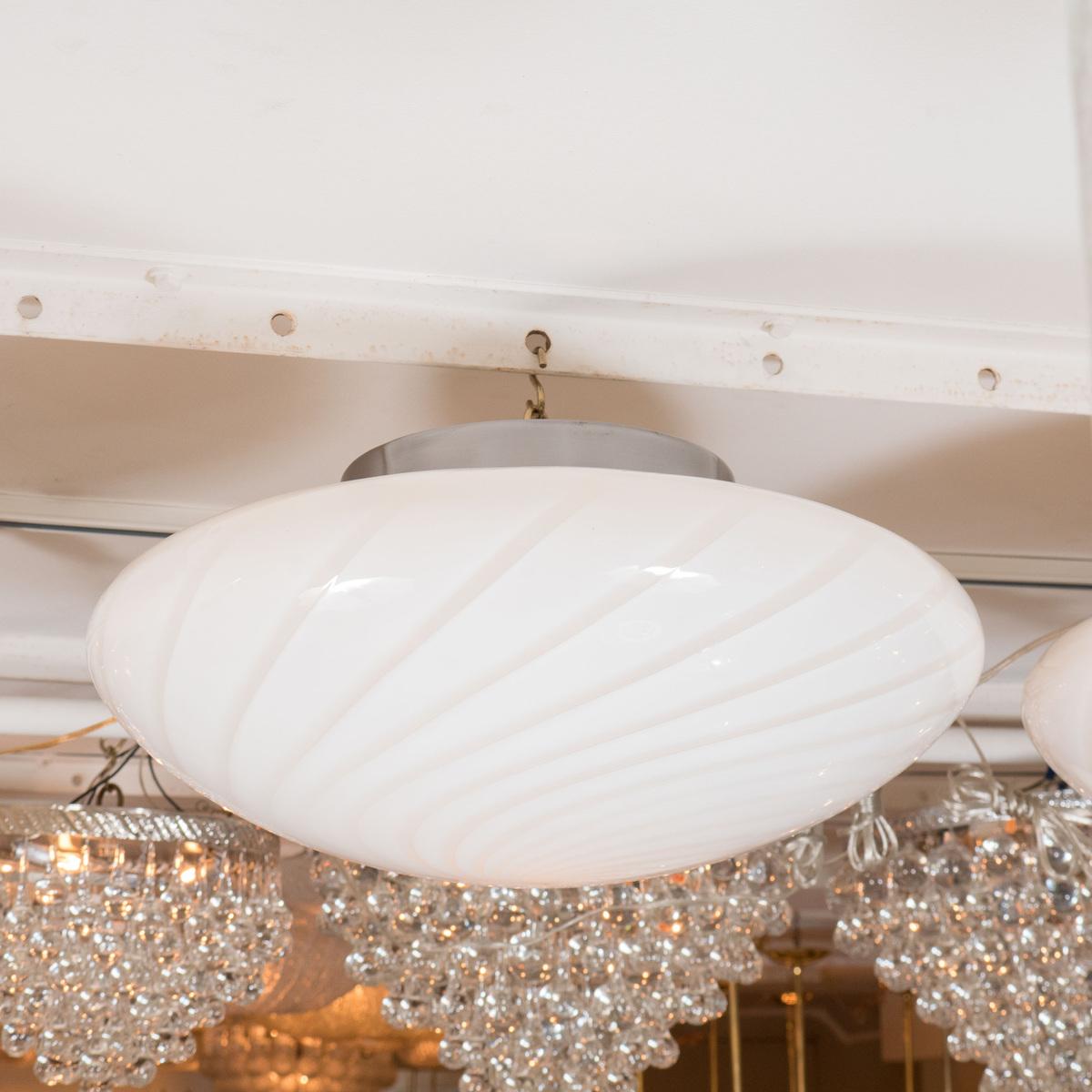 Circular lattimo glass flush mount ceiling fixture.