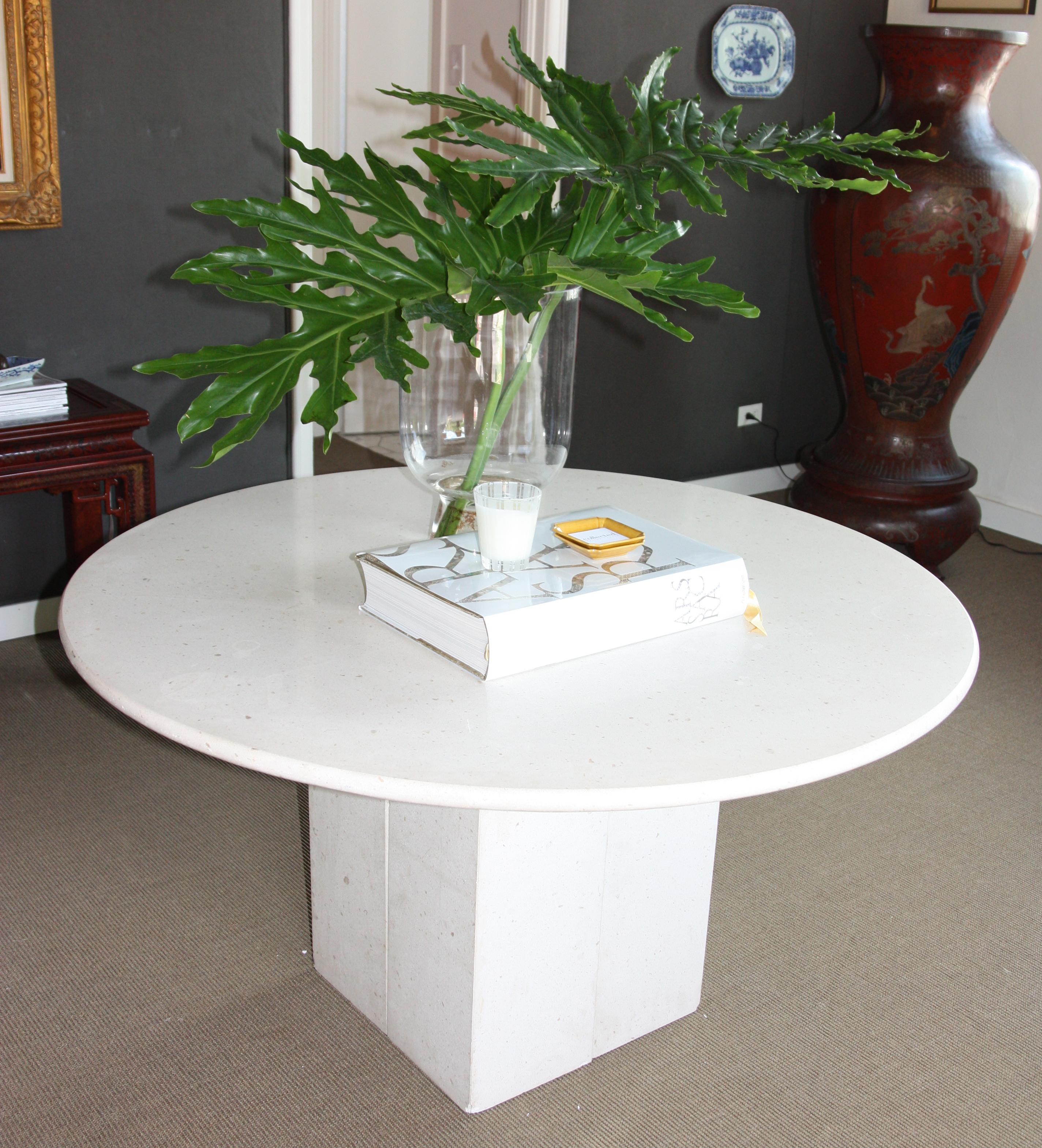 Circular limestone table with square base. The base is modular and can be adjusted to create different shapes.