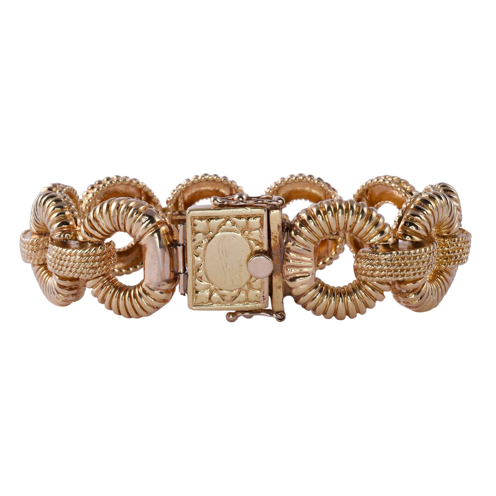 Vintage circular link 18K gold bracelet, circa 1960-70. This vintage bracelet features scalloped circular links crafted in 18 karat yellow gold. The 18K link bracelet weighs 77.1 grams. [KIMH 577]

Dimensions
7.625