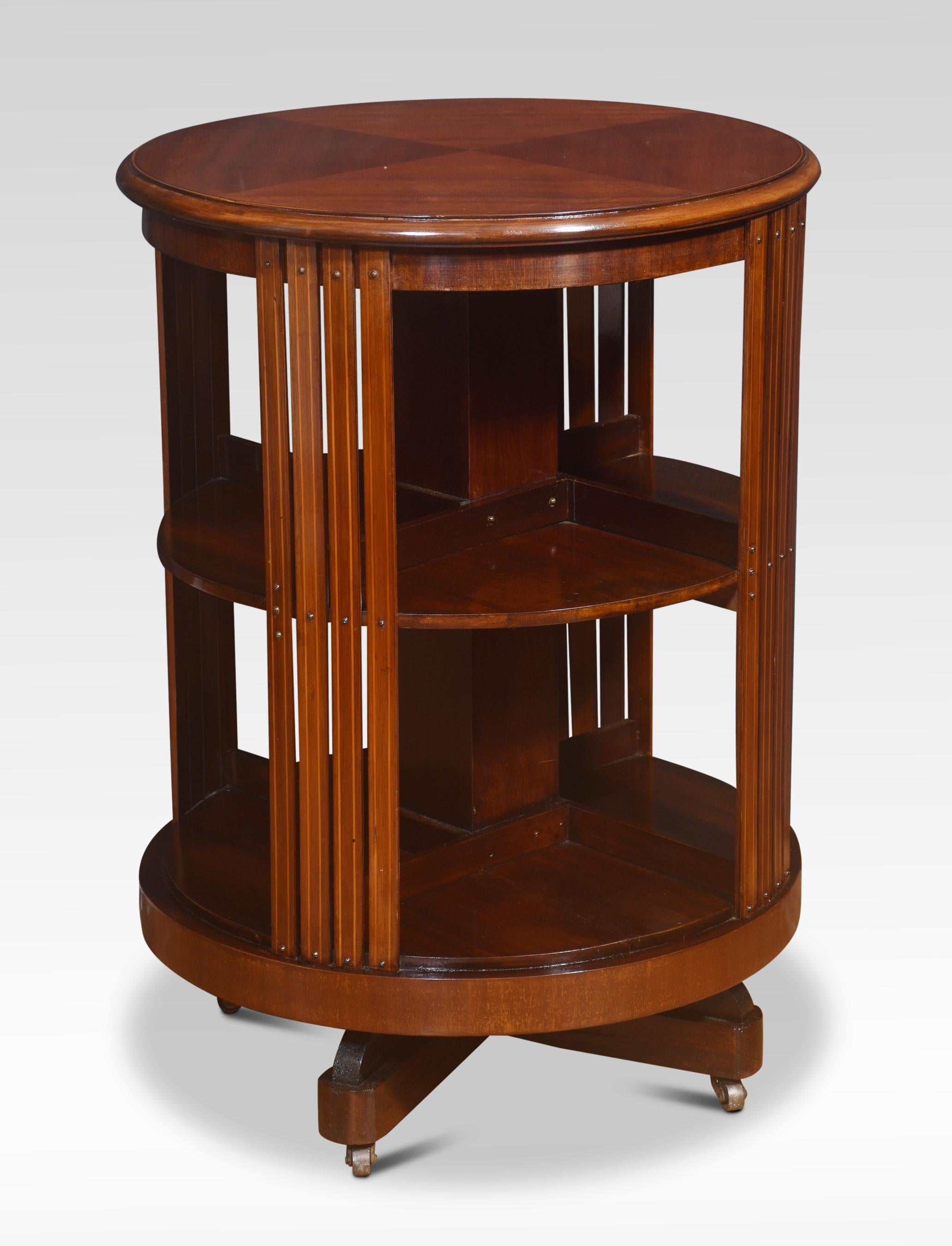 Circular revolving bookcase, the quarter veneered mahogany top with moulded edge, above an argument of shelves. All raised up on cruciform base with castors.
Dimensions
Height 31.5 Inches
Width 23 Inches
Depth 23 Inches