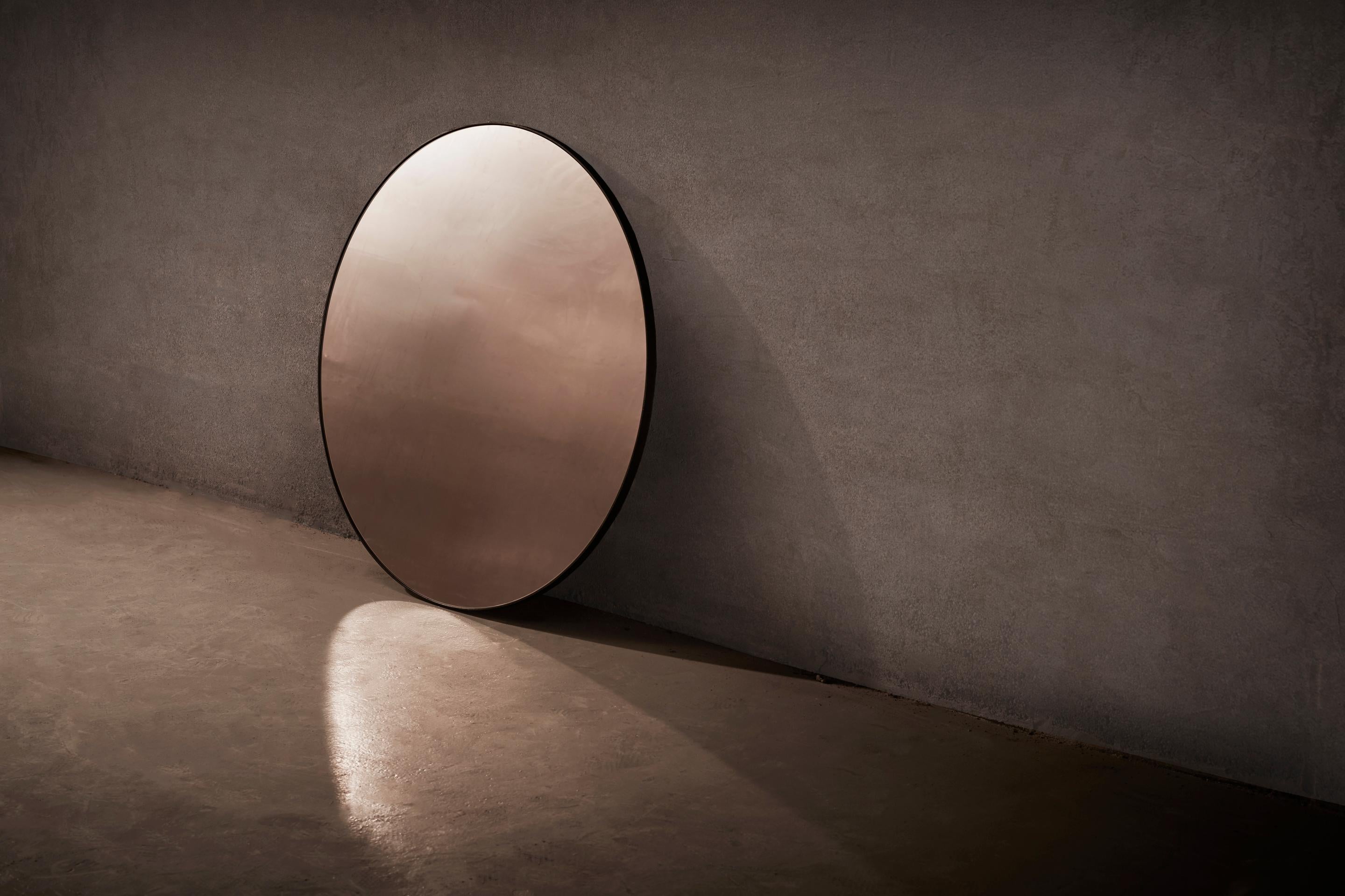 Circular mirror handcrafted and signed by Novocastrian

Wall-mounted circular mirror with blackened steel frame. Bronze or grey tinted glass available. Supplied with two screw fixing points to rear face. Handcrafted in the North East,