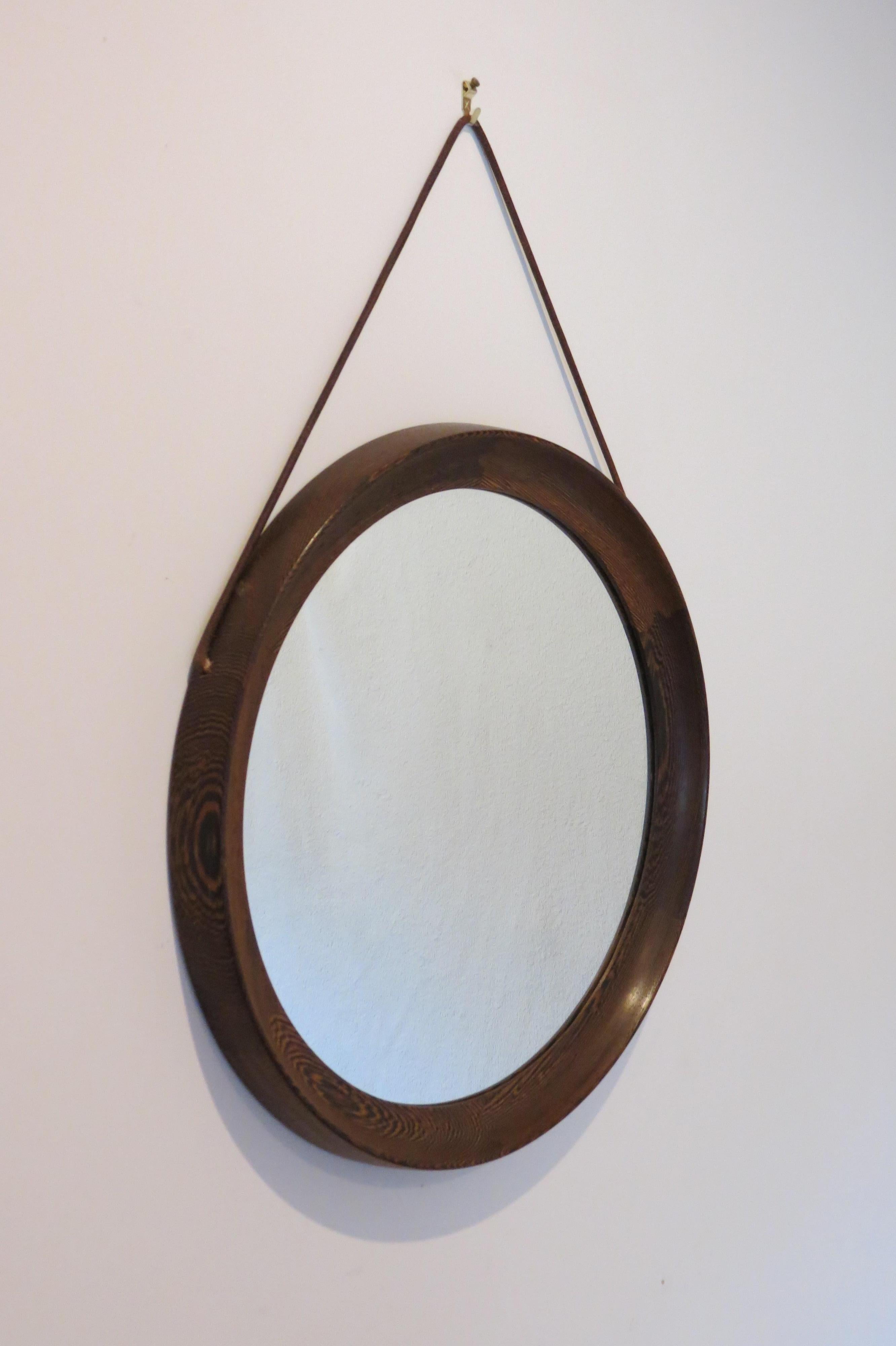 Swedish circular wall hanging mirror by Uno & Östen Kristiansson and manufactured by Luxus, Sweden.

Solid Wengé with detailed joints, glass mirror plate and leather strap.

Good vintage condition.

ST732.