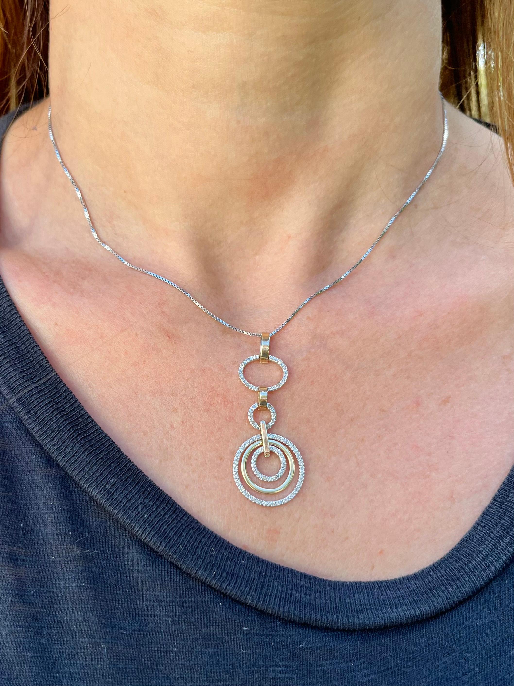 Circular multi-ring pendant necklace mounted with 1/4 carats in natural pave set diamonds and 10k solid gold. A beautiful design with a good amount of weight to ensure it stays put on the middle chest. 

An excellent and affordable gift that's ideal