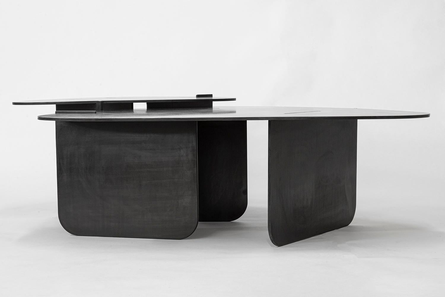 TABLE NO. 15 - NESTING SET
J.M. Szymanski
d. 2019

52'' D  36'' W  13'' H  - COFFEE  
32'' D  22'' W  15'' H - SIDE

This Noguchi-inspired coffee tables are handcrafted in 3/8” thick steel, with a natural black patina and wax finish, to create an