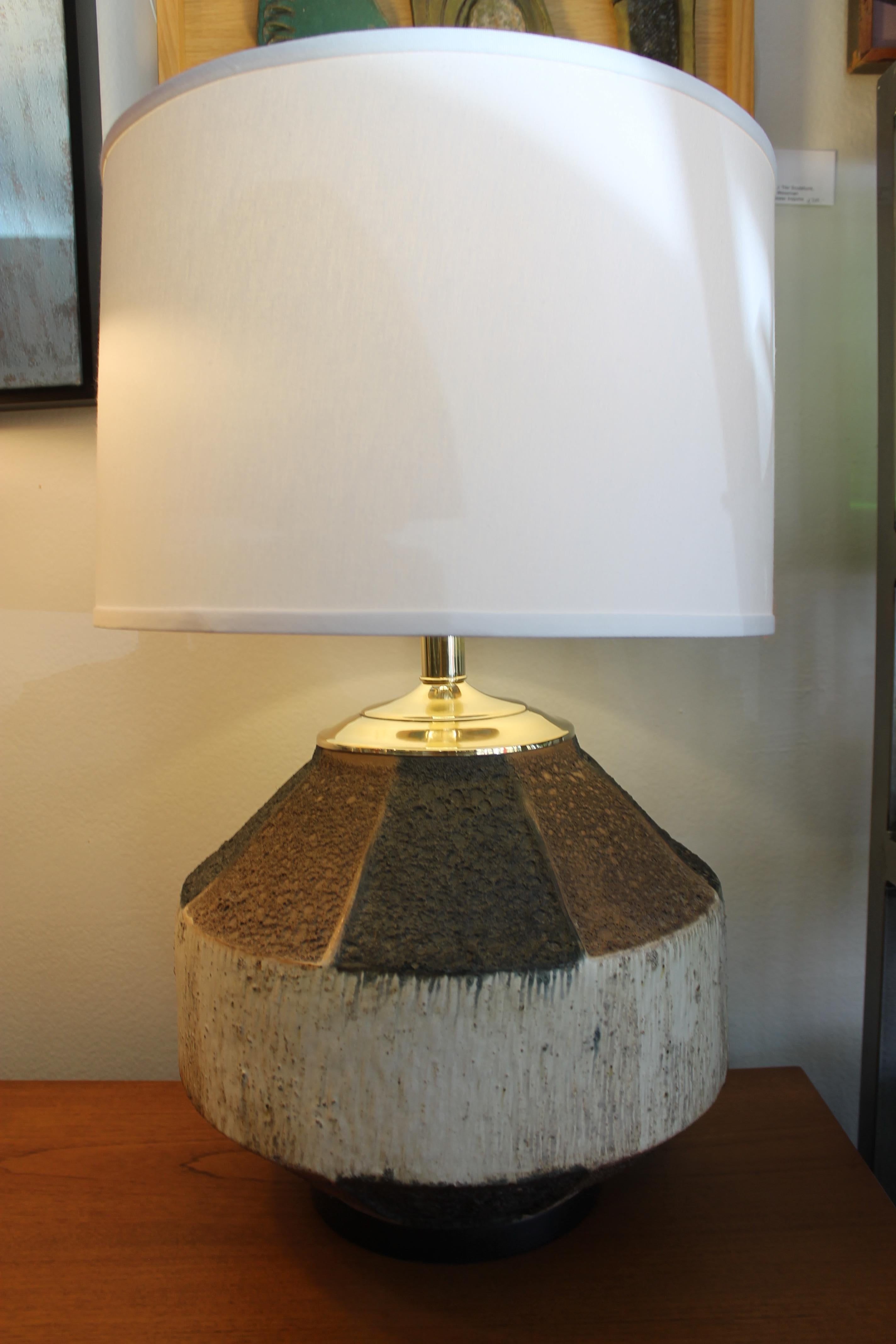 Circular ceramic lamp with octagon lava pattern on top of circular middle portion. Lamp has been professionally rewired for 3-way light bulb. New brass neck and hardware. Lamp measures 19.5