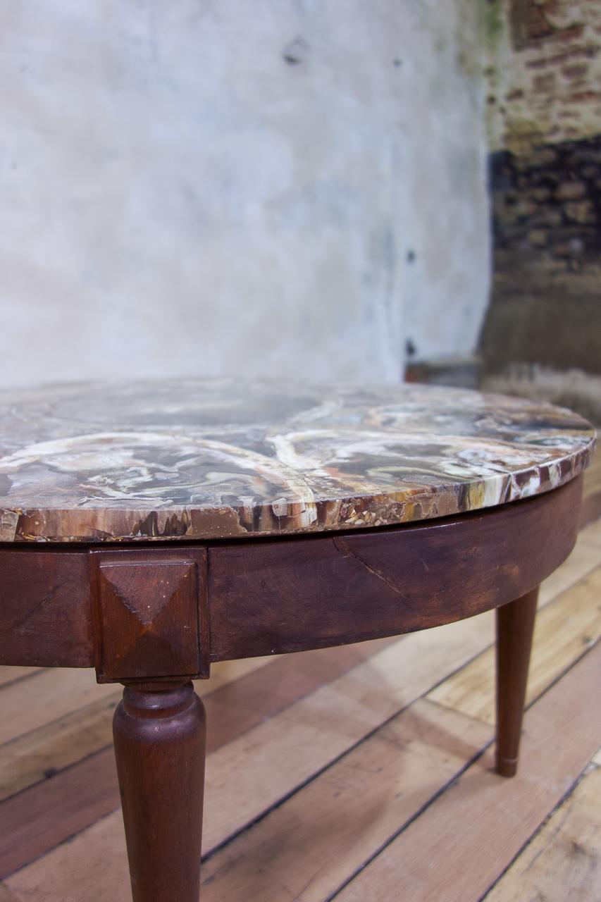 An extraordinary petrified wood low table. Raised on elongated elegant tulip turned legs, with the base dating from the late 19th-early 20th century. Displaying a circular petrified wood top, probably sourced from Madagascar and dating from the