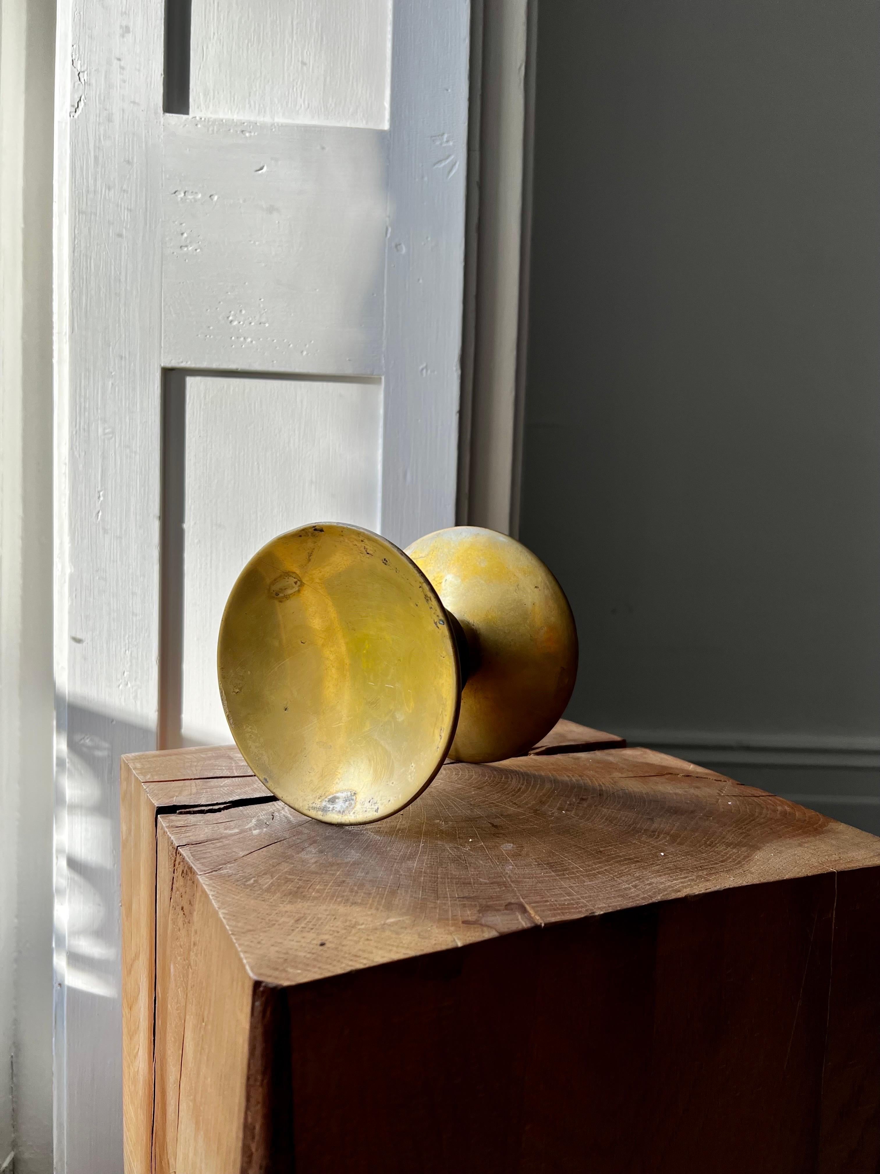 Circular push-pull door handle in bronze, mid-20th century, France.

A simple elegant handle, made up of two separate round pieces; each side with a slightly concave dish and wide stem. The components are in good vintage condition with lots of signs