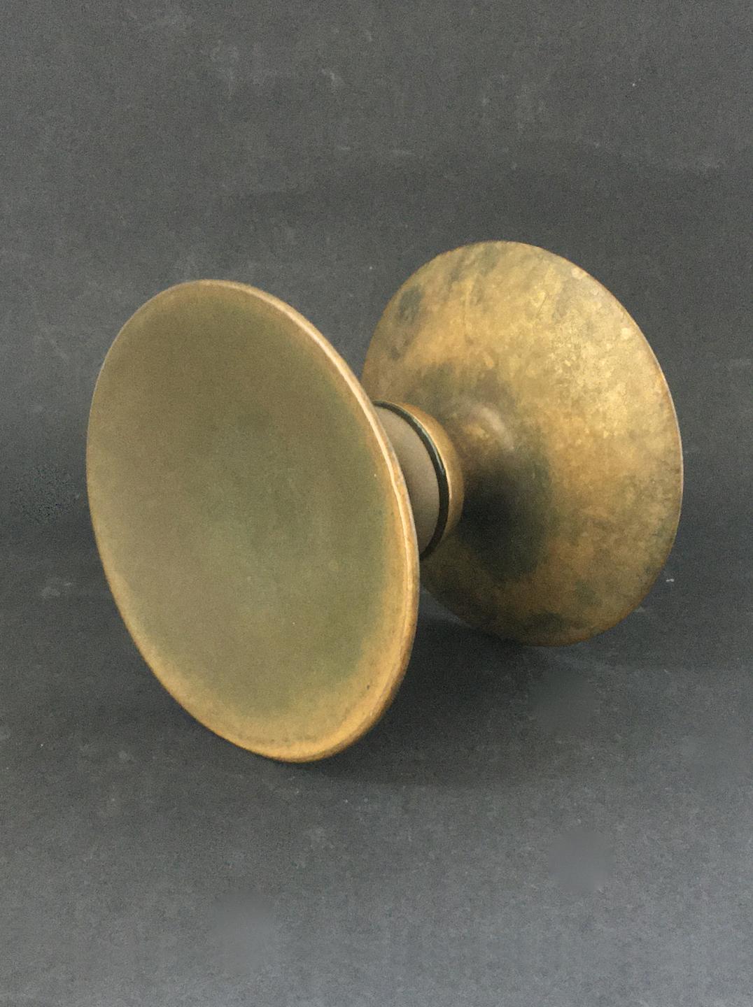 Circular push-pull door handle in bronze, mid-20th century, France.

A very simple elegant handle, made up of two separate round pieces; each side with a slightly concave dish and wide stem. The components are in good vintage condition with an