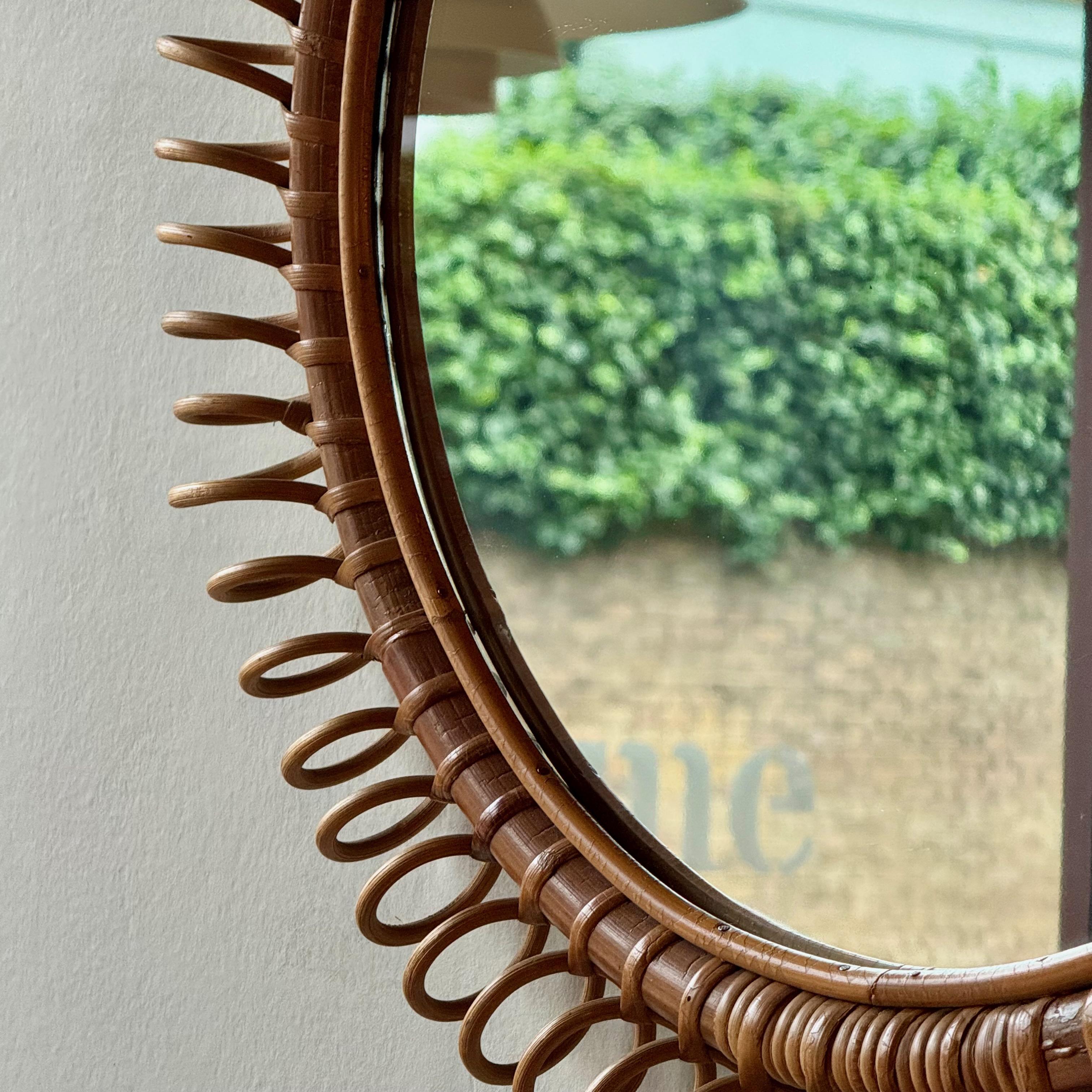 Miroir mural circulaire avec cadre en rotin, probablement fabriqué en Italie dans les années 1950-1960. 

Le rotin est un matériau polyvalent qui a été favorisé à l'époque victorienne et qui a connu un regain de popularité dans les années 1950.