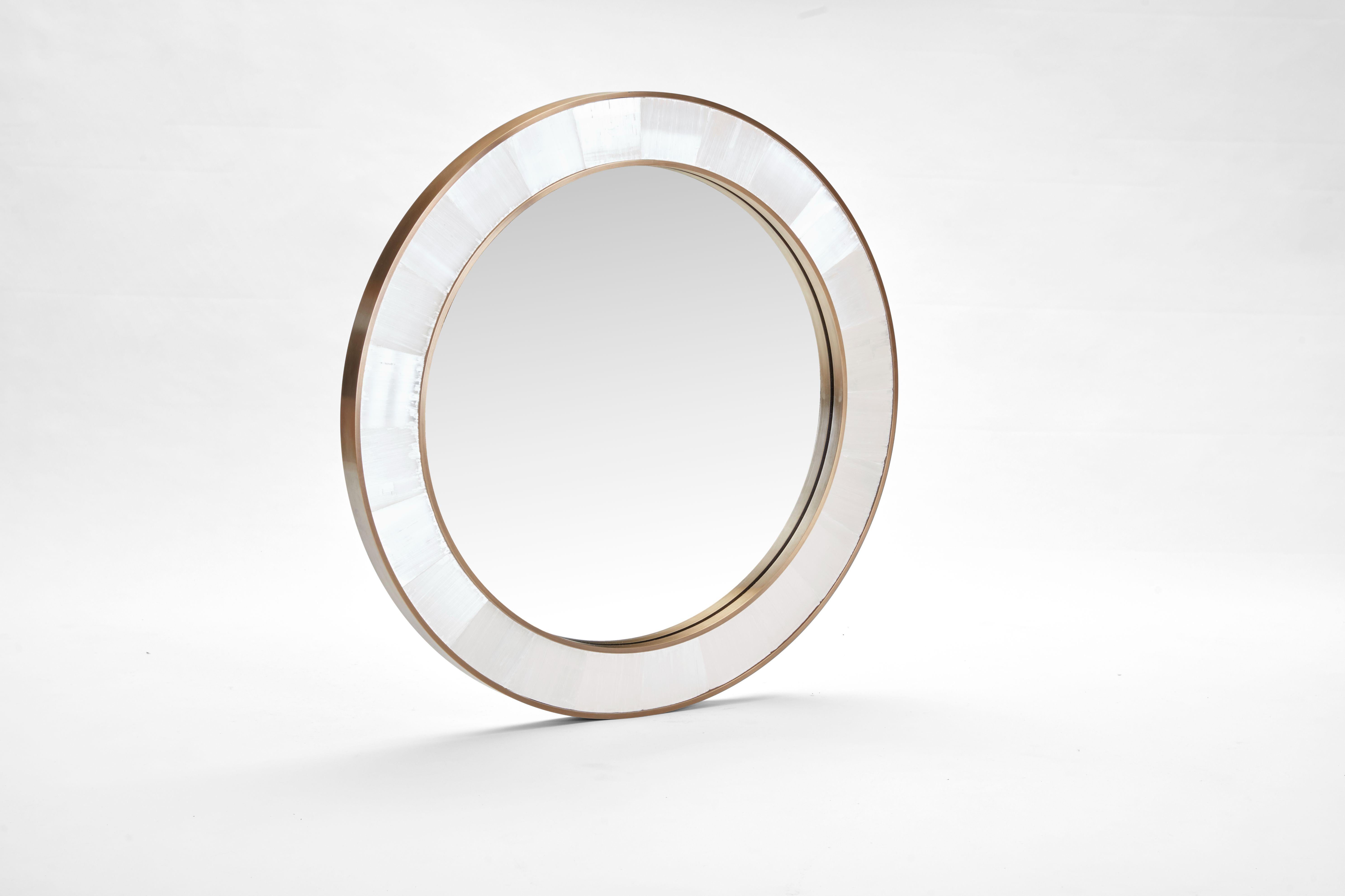 Circular Selenite and Brass Wall Mirror
Diameter 100 cm (39.37 inches) 
12 weeks lead time. 

Selenite is said to be a powerful healing crystal that promotes peace and calm, mental clarity, and well-being. It's also believed by some that this