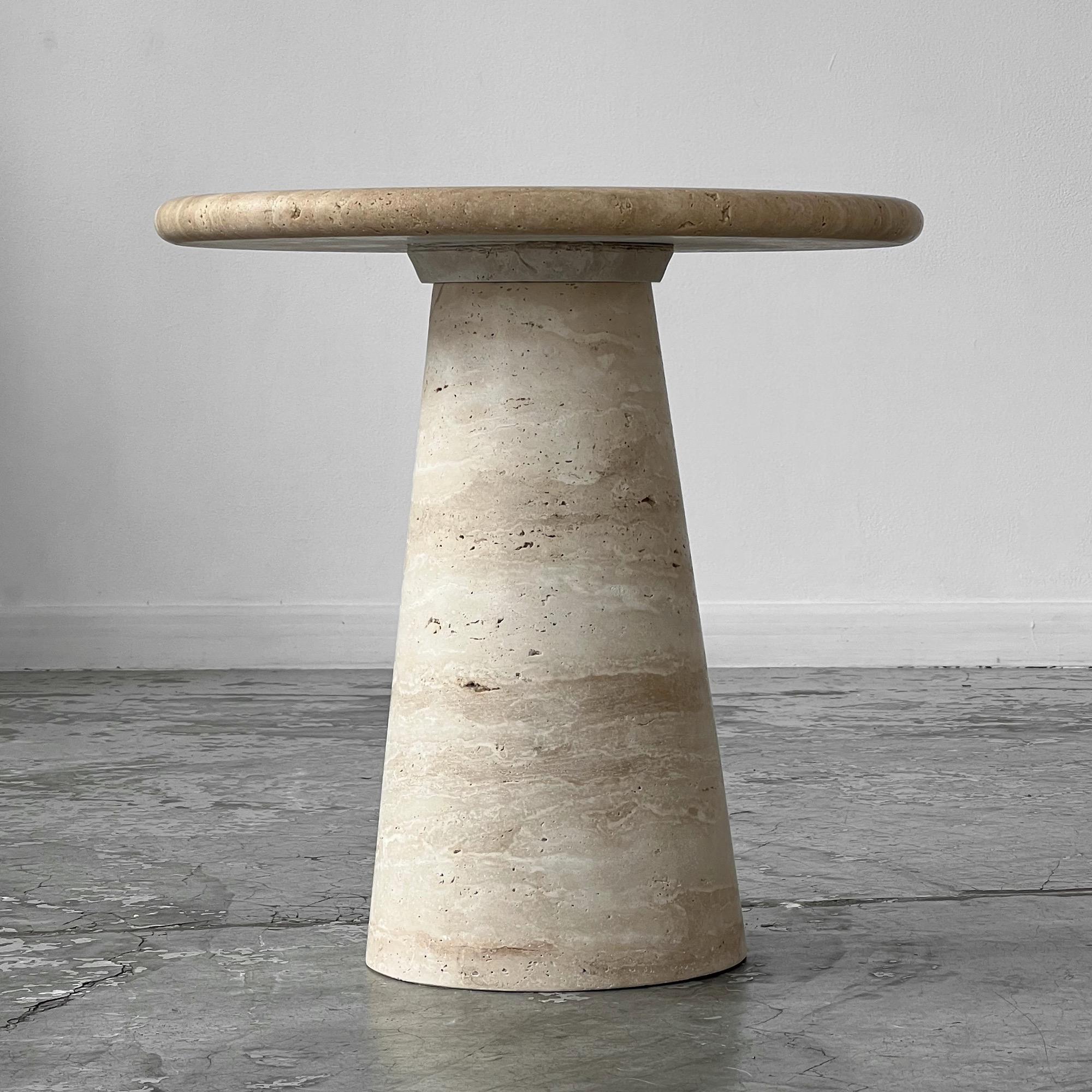 Table in untreated natural travertine. The overall structure is in travertine. The circular top rests directly on a solid conical base. On a solid conical base. 
In very good condition. 
8 available.