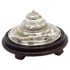 Circular silver and wooden inkwell