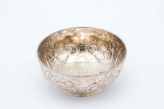 Circular silver bowl with floral motifs