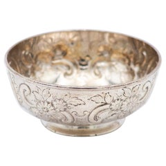 Circular silver bowl with floral motifs