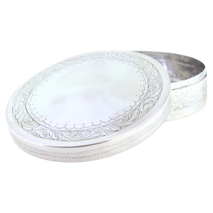 Circular silver box for rosaries with engraved floral motifs