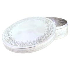 Circular silver box for rosaries with engraved floral motifs