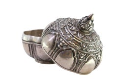 Circular silver box with embossed fruit and knob on the lid