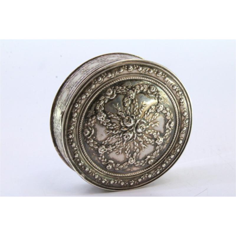 European Circular silver box with floral reliefs and a hinged lid For Sale