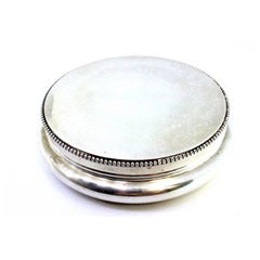 Circular silver box with pearl trim on the base and removable lid