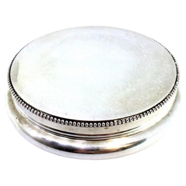 Circular silver box with pearl trim on the base and removable lid