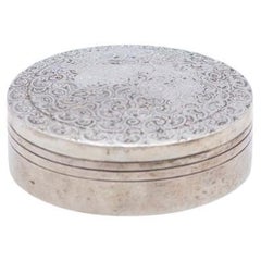 Circular silver box with plant reliefs on the removable lid