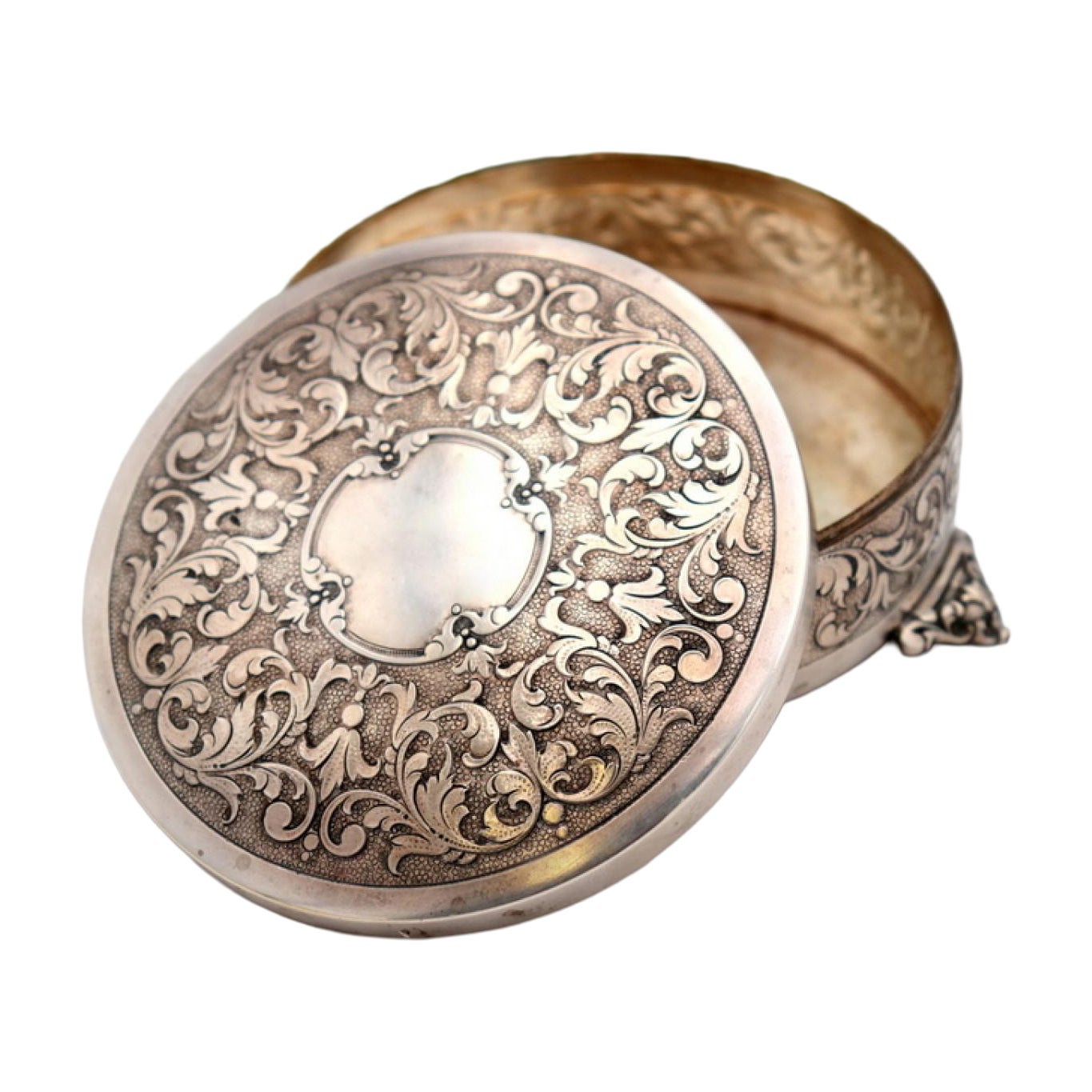 Circular silver box with reliefs and monogram card