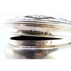Circular silver box with reliefs on the removable lid
