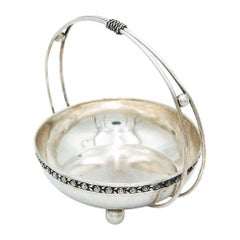 Circular silver fruit bowl with double fixed handle