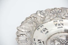 Circular silver fruit bowl with scalloping