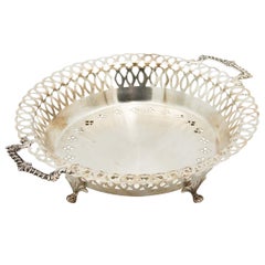 Circular silver fruit bowl with wire rack