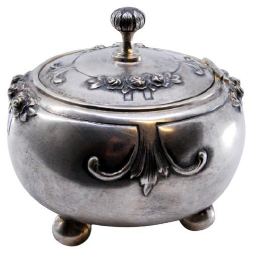 Circular silver jewelry box with four support feet
