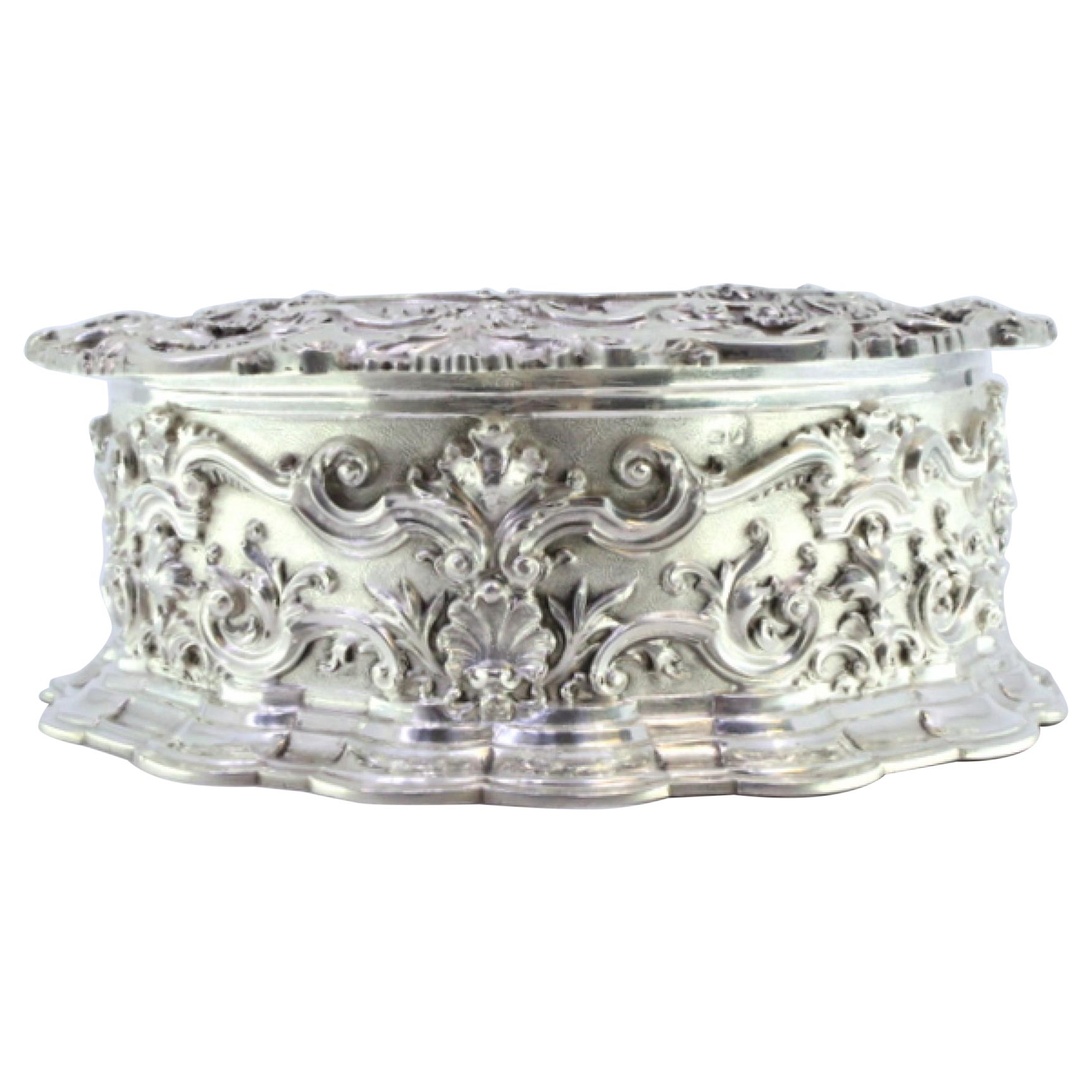 Circular silver jewelry box with shells, scrolls and ancient-lady figure