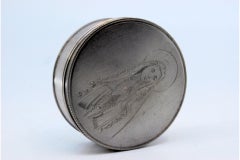 Circular silver pill box with engraved Our Lady of Fatima lid