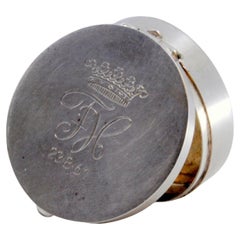 Circular silver pill box with engraving on the hinged lid