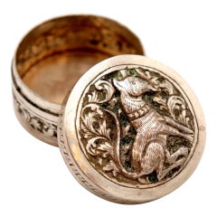 Circular silver rosary box with embossed dog figure