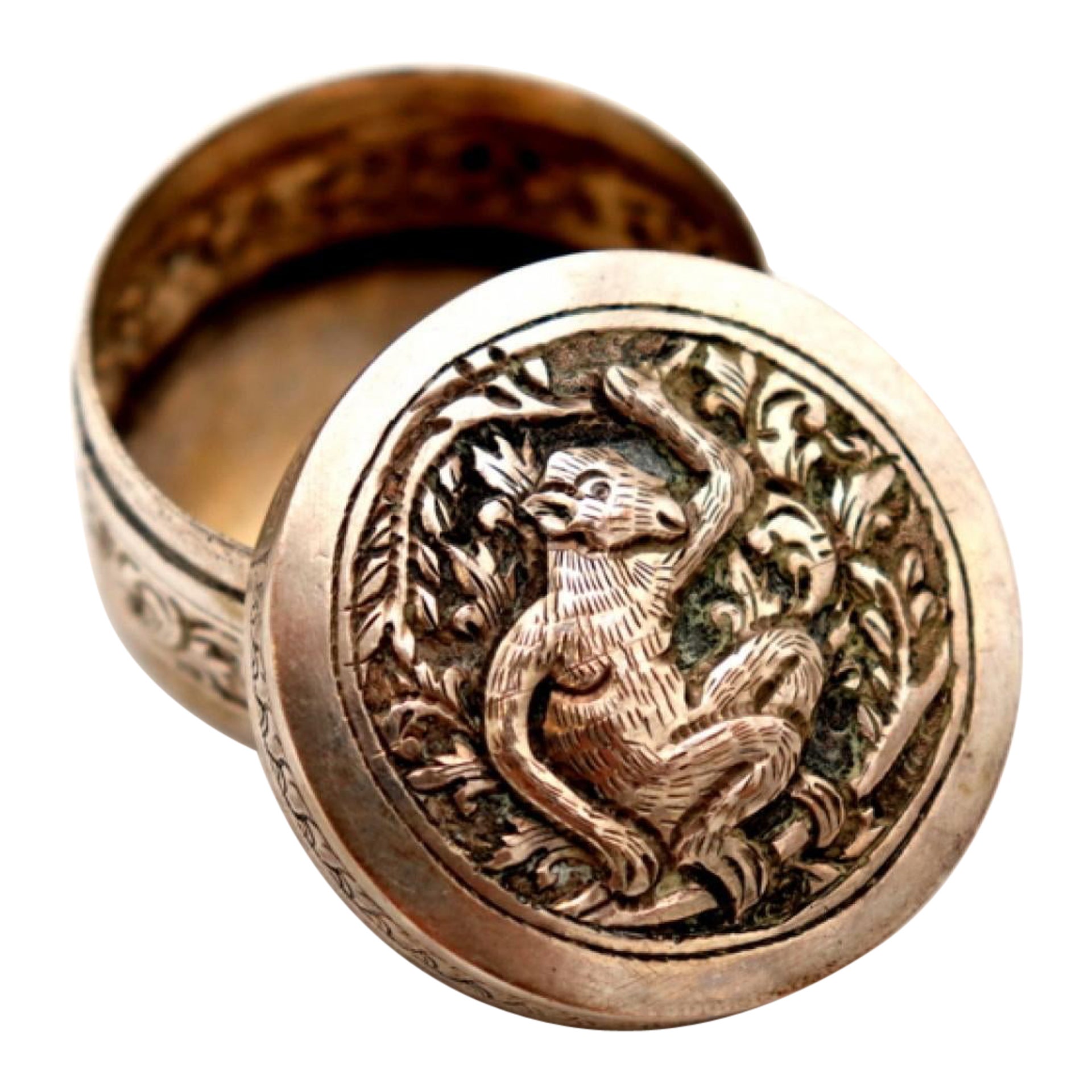 Circular silver rosary box with embossed dog figure
