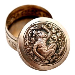 Circular silver rosary box with embossed dog figure