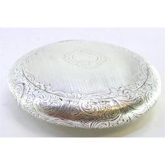 Circular silver rosary box with guilloché and monogram on gold interior