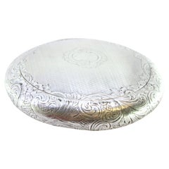 Circular silver rosary box with guilloché and monogram on gold interior