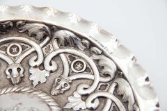 Circular silver tray with reliefs in the center
