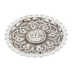 Circular silver tray with reliefs in the center