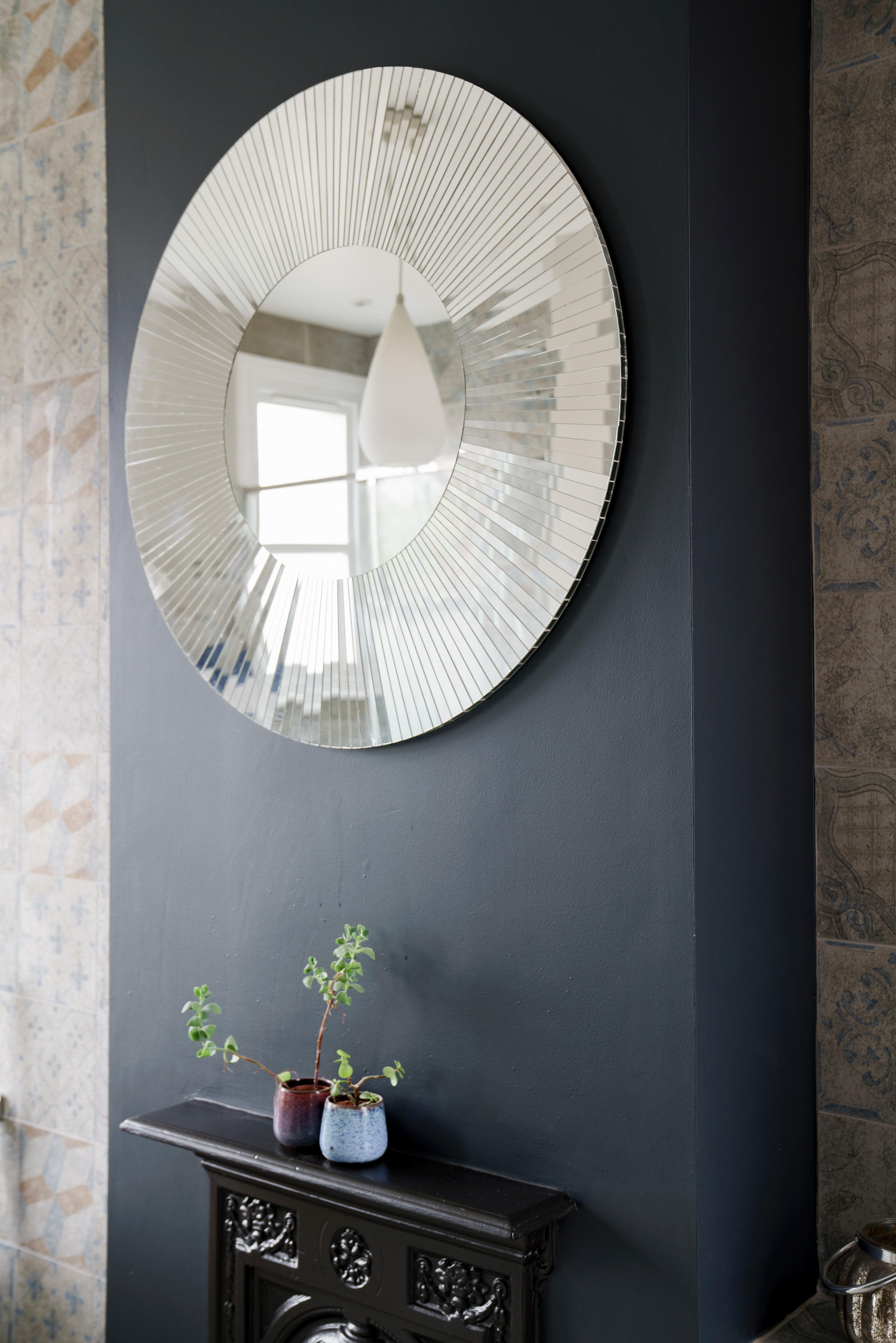 The circular Sunray mosaic mirror handmade in UK by Claire Nayman. Each piece of mirror has been individually handcut creating beautiful reflections and a unique finish. The Frame and central mirror sit flush with each other and this mirror has a