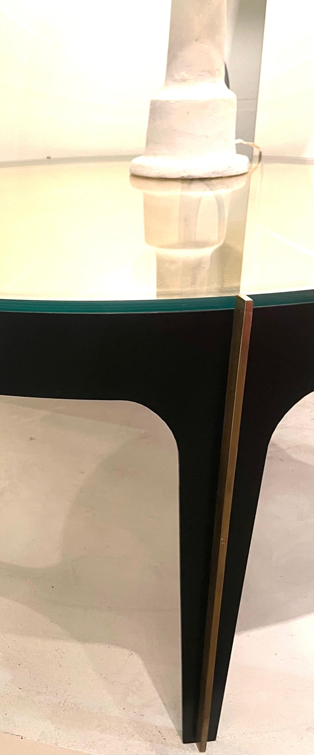  The large piece of mirrored curved glass create a beautiful
optical effect (lentil). This one is resting on a blackened bronze 
base with brass accents.
Attributed to Max Ingrand for Fontana Arte.
Italy around 1950.